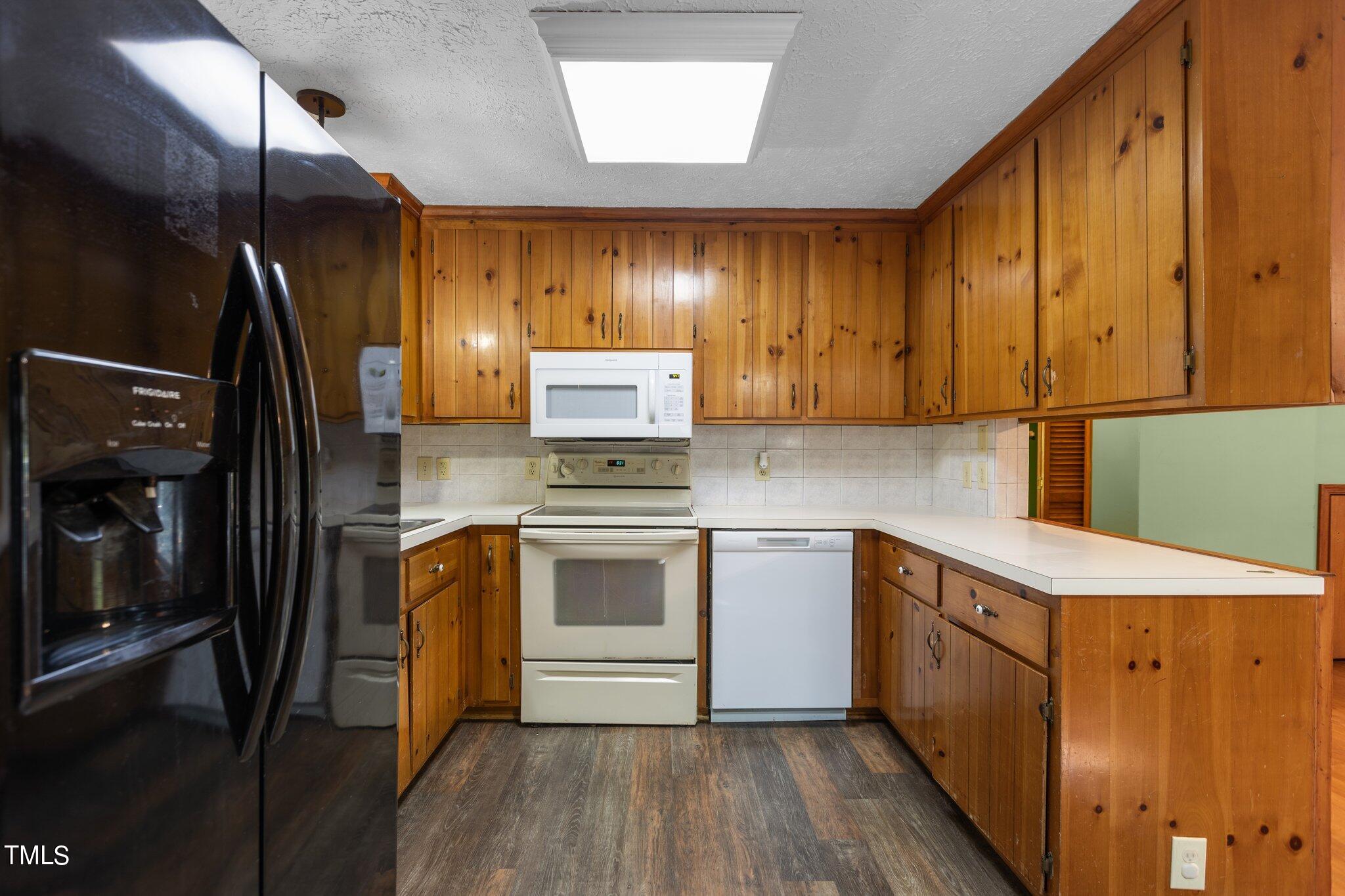 1819 Chambers Loop Road Timberlake, NC 27583 - Photo 10 of 41 a kitchen with a sink a refrigerator and cabinets