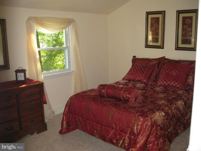 1619 Ruxton Road Edgewater, MD 21037 - Photo 5 of 10 a bed sitting in a bedroom next to a window