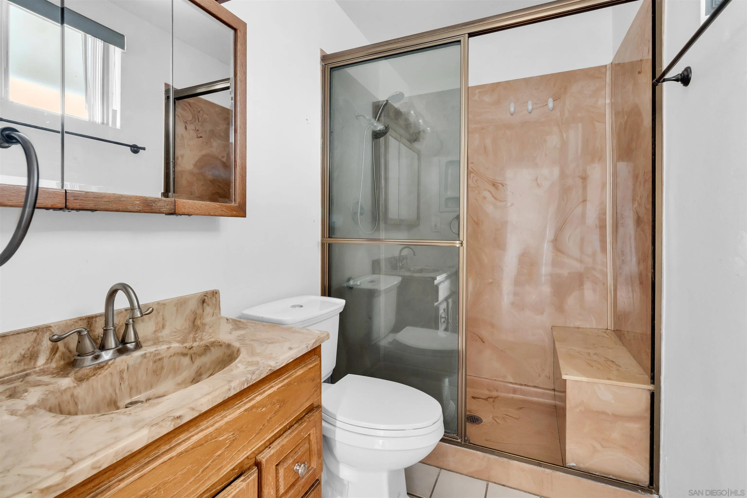 901 St George Court Spring Valley, CA 91977 - Photo 17 of 32 a bathroom with a granite countertop sink toilet and shower