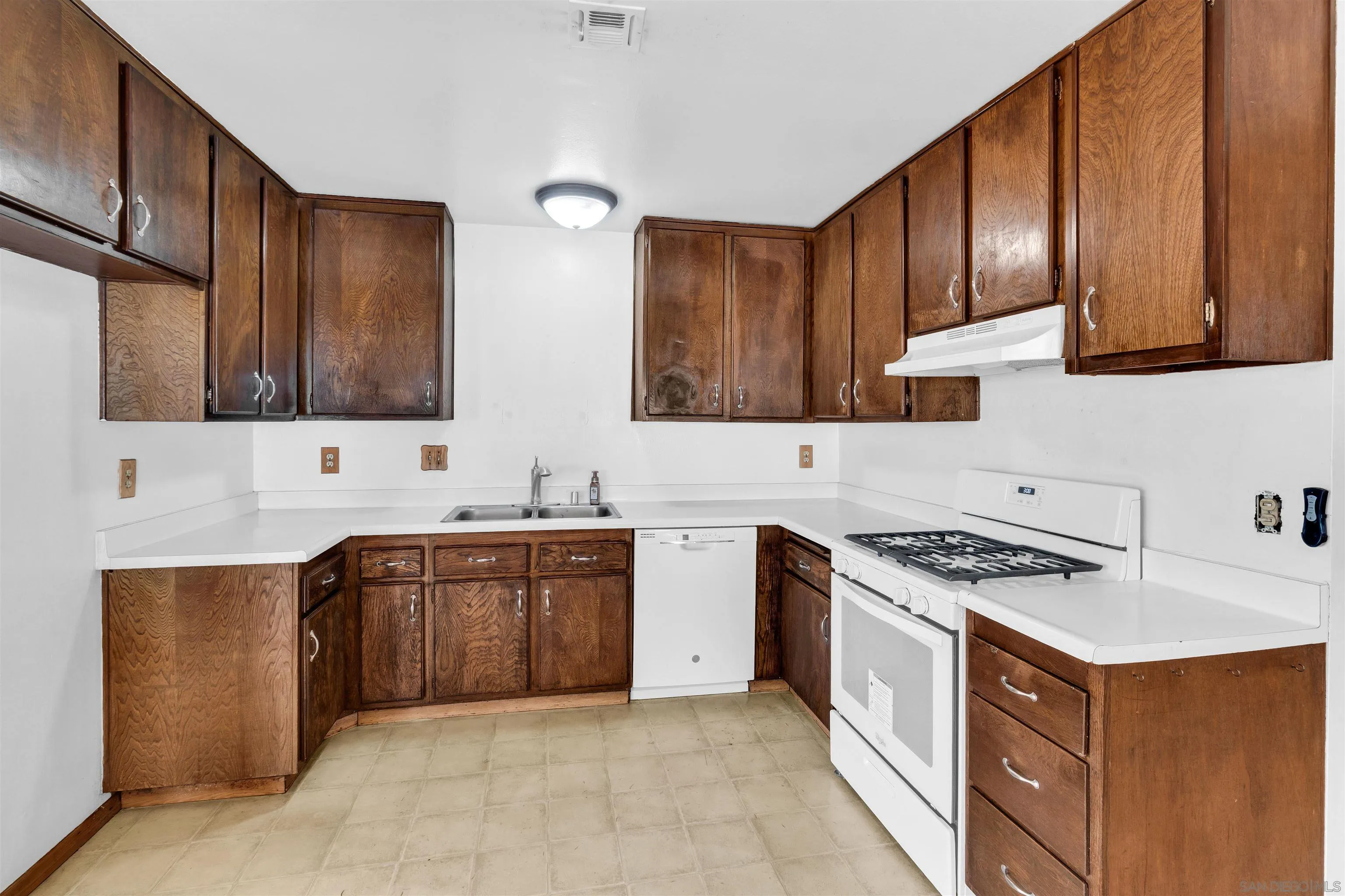901 St George Court Spring Valley, CA 91977 - Photo 9 of 32 a kitchen with stainless steel appliances granite countertop wooden cabinets a stove top oven a sink and dishwasher