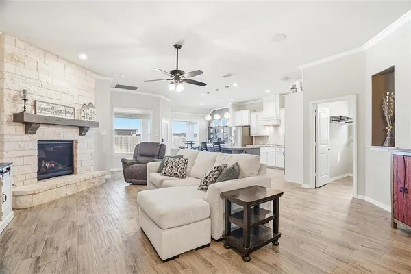 a living room with furniture a fireplace and a flat screen tv