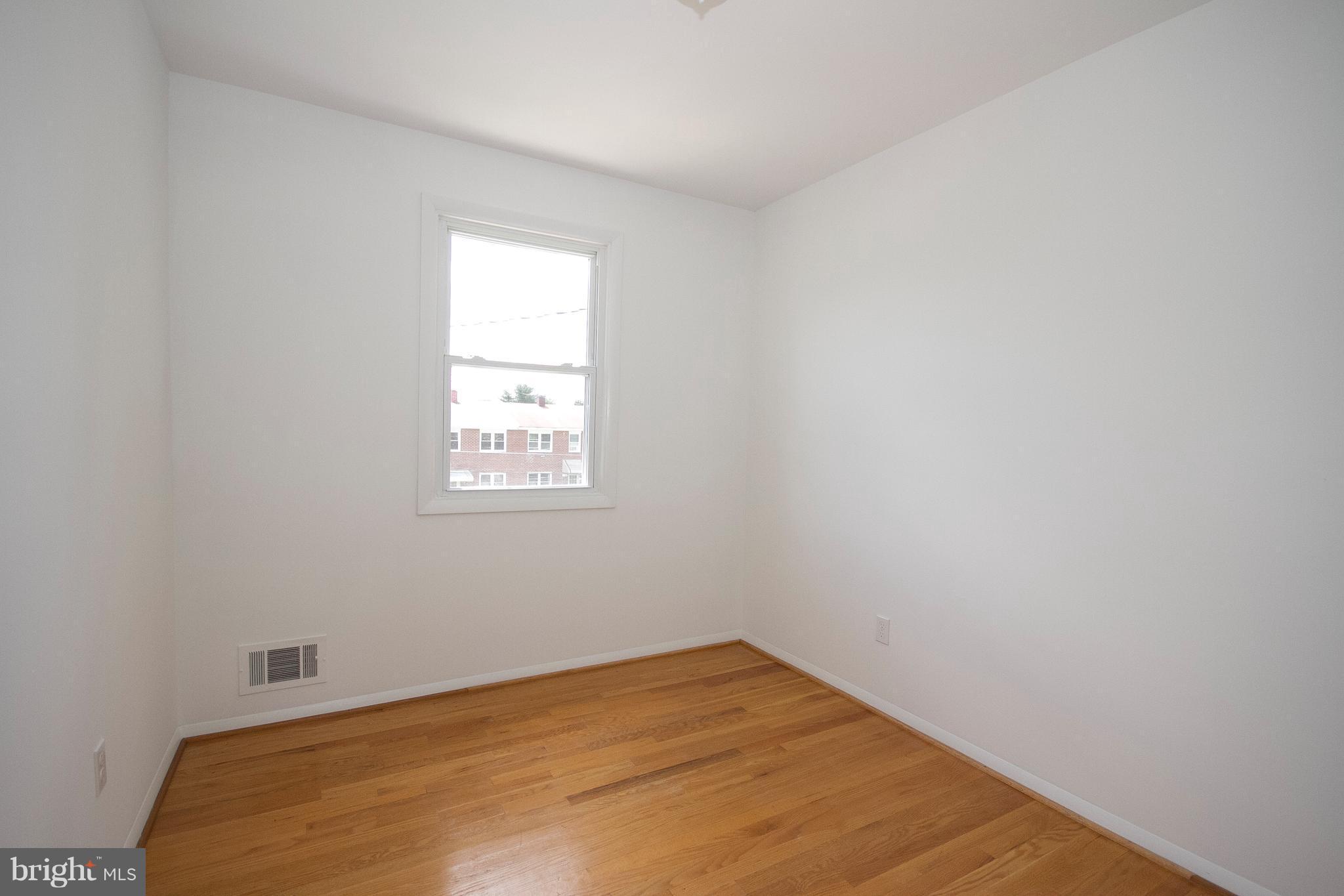 6936 Blanche Road Baltimore, MD 21215 - Photo 12 of 15 a view of a big room with wooden floor and windows in a room