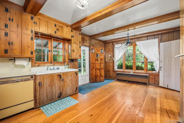 a view of a kitchen with a sink and wooden floor
