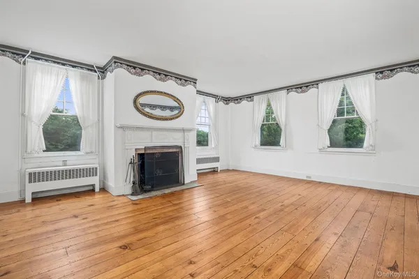 a view of a livingroom with a fireplace and window