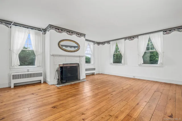 a view of a livingroom with a fireplace and window