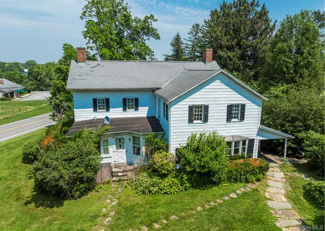 a front view of house with yard and green space
