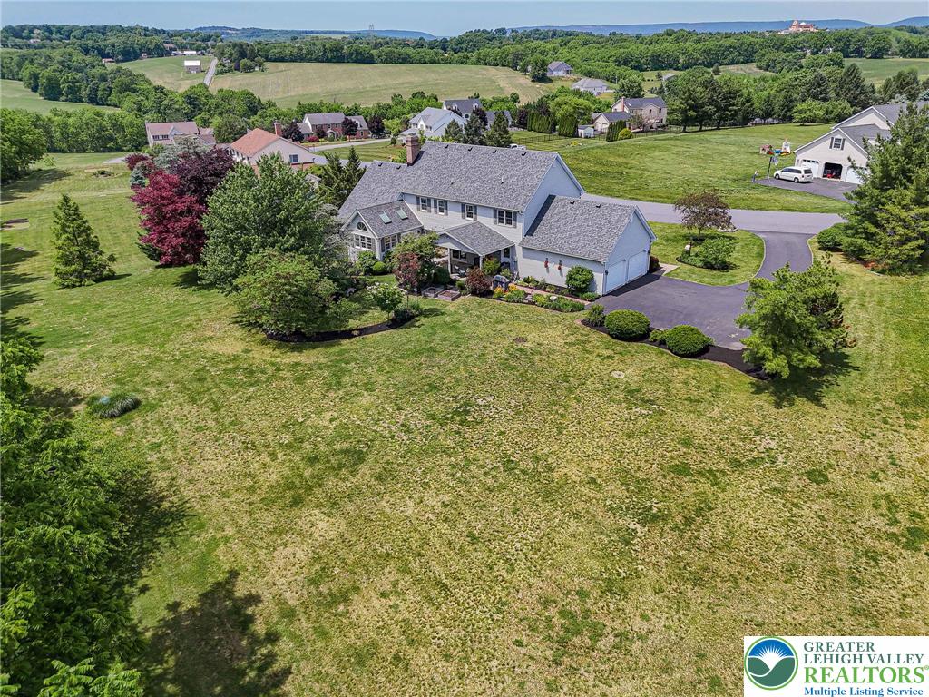 4542 Springfield Drive Coplay, PA 18037 - Photo 82 of 89 An aerial perspective reveals a beautiful home nestled on a vast, well-maintained lawn.