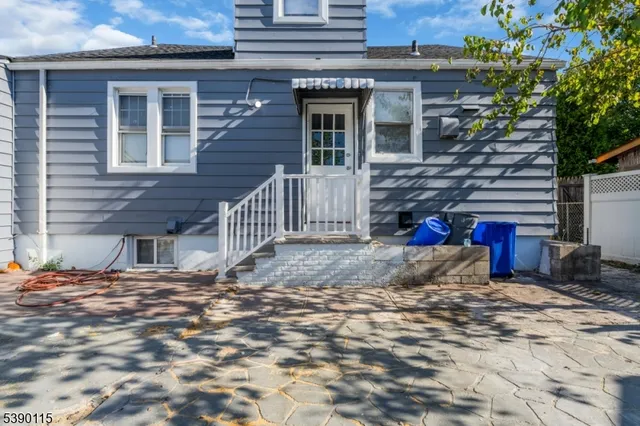 a view of a house with a wooden fence