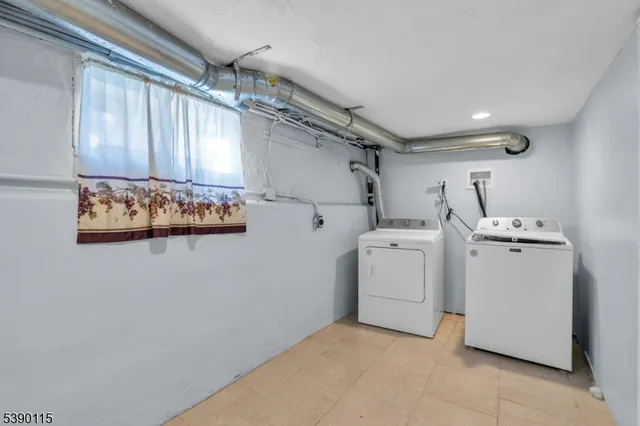 a view of storage and utility room with washer and dryer
