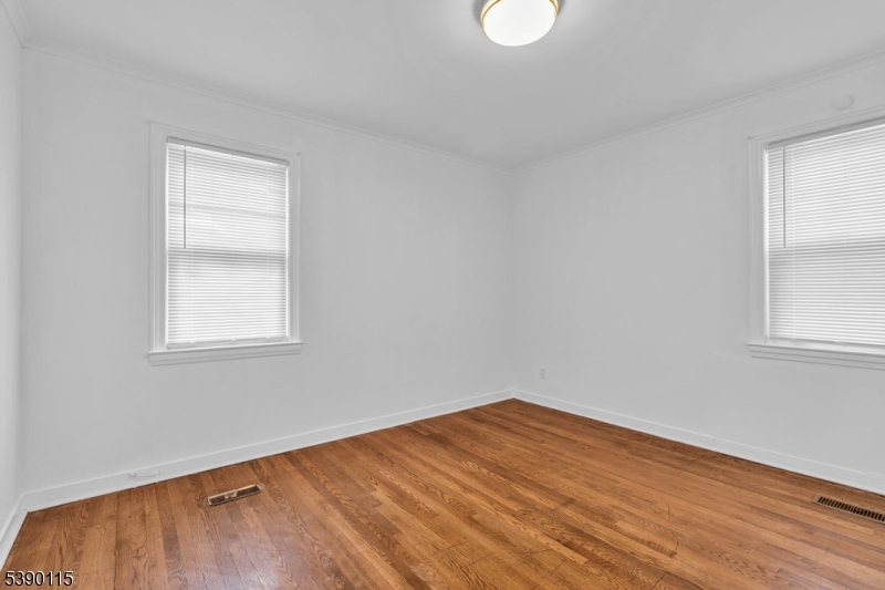 2144 Tyler Street Union, NJ 07083 - Photo 8 of 21 a view of empty room with wooden floor and fan