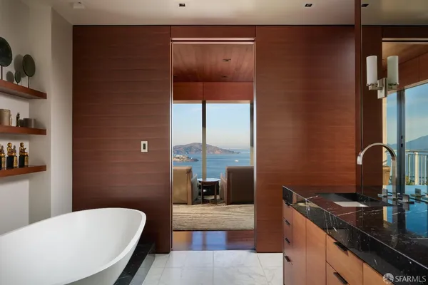a spacious bathroom with a double vanity sink a mirror a bathtub and shower