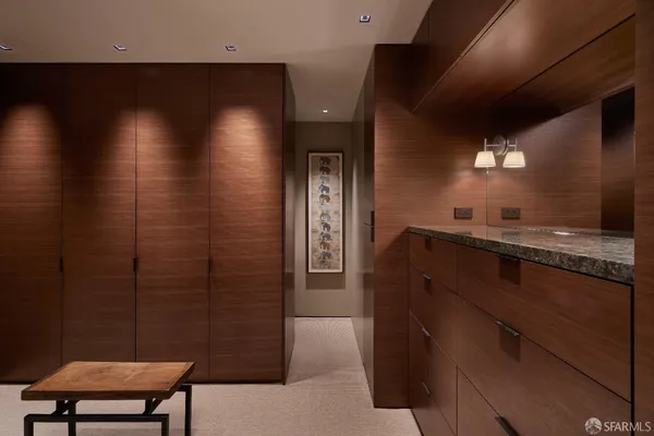 a bedroom with a bed a bookshelf and a flat screen tv