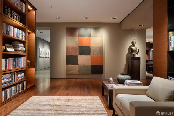 a living room with fireplace furniture and floor to ceiling windows