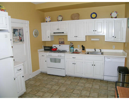 30 Kilsyth Road, Unit 1 Brookline, MA 02445 - Photo 6 of 12 a kitchen with cabinets and appliances