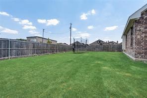 698 Harper Drive Fate, TX 75087 - Photo 15 of 18 a view of a backyard with a garden and plants