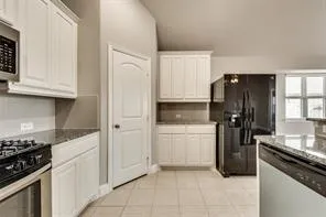 a kitchen with a refrigerator stove and cabinets