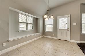 698 Harper Drive Fate, TX 75087 - Photo 7 of 18 an empty room with chandelier fan and windows
