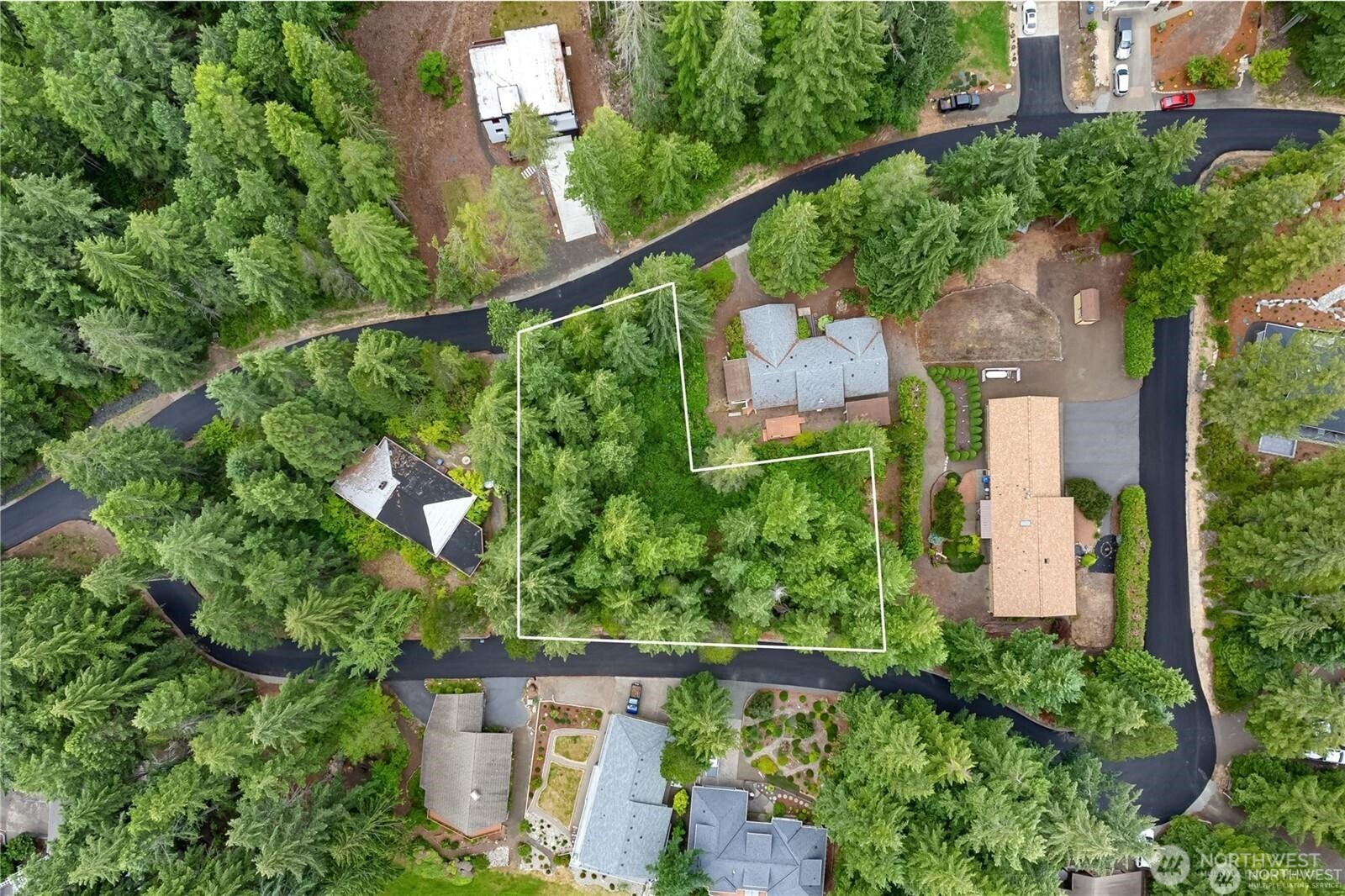 an aerial view of a house with a yard and lake view