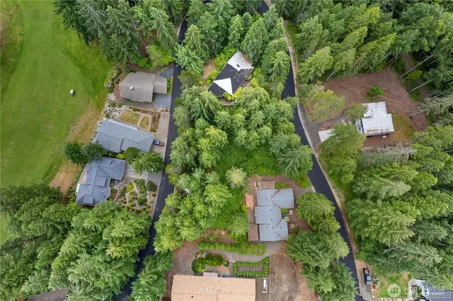 an aerial view of a house with a yard basket ball court and outdoor seating