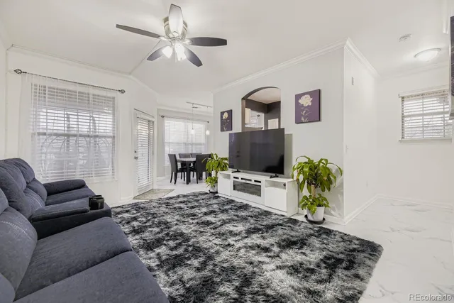 a bedroom with furniture and a flat screen tv