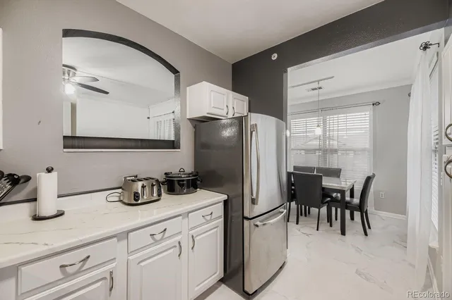 a kitchen with refrigerator and table