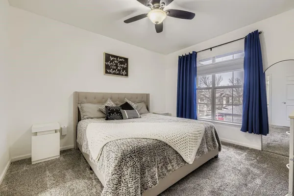 a bedroom with a large bed and a large window