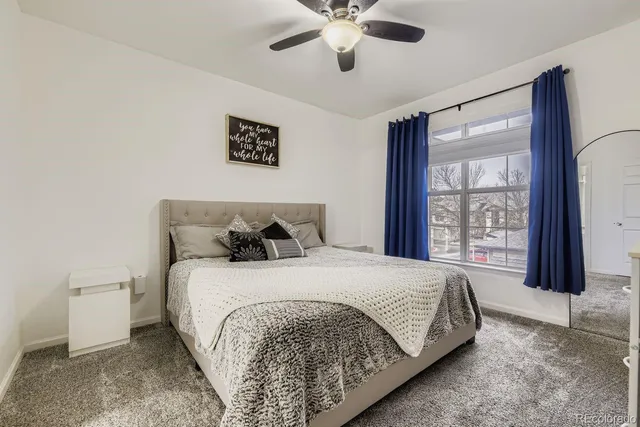 a bedroom with a large bed and a large window
