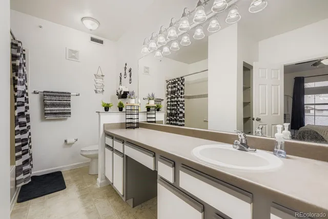 a bathroom with a sink double vanity and a toilet