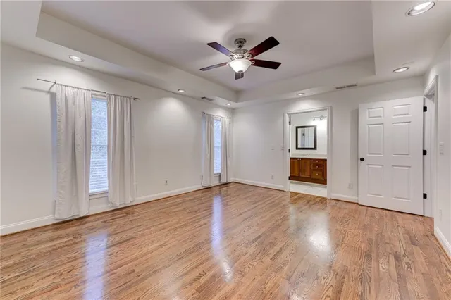 a bathroom with a granite countertop sink a shower a and a mirror