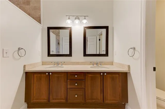 a white toilet sitting next to a bathroom sink