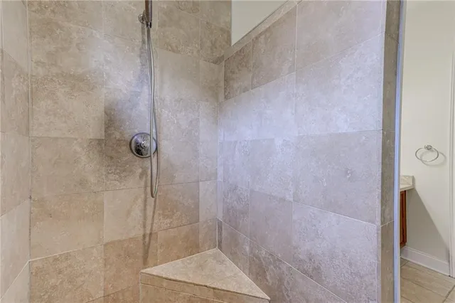 a front view of a house with garden and sitting area