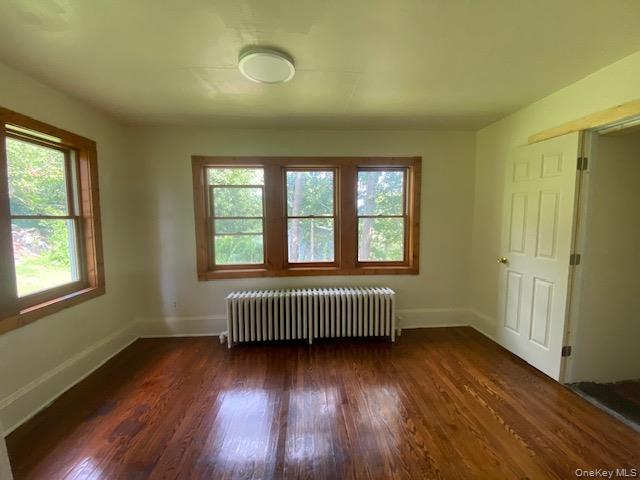 72 North Liberty Drive, Unit 1 Stony Point, NY 10980 - Photo 5 of 8 an empty room with wooden floor and windows