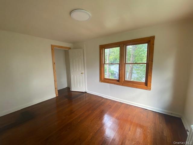 72 North Liberty Drive, Unit 1 Stony Point, NY 10980 - Photo 6 of 8 an empty room with wooden floor and windows