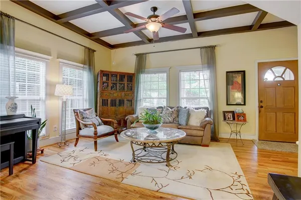 a living room with furniture and wooden floor
