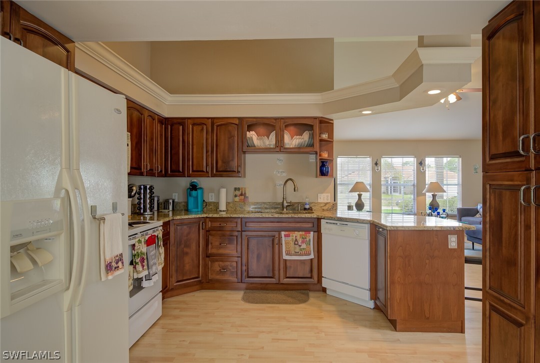18265 Sycamore Road Fort Myers, FL 33967 - Photo 8 of 29 a kitchen with stainless steel appliances granite countertop a refrigerator and a stove top oven