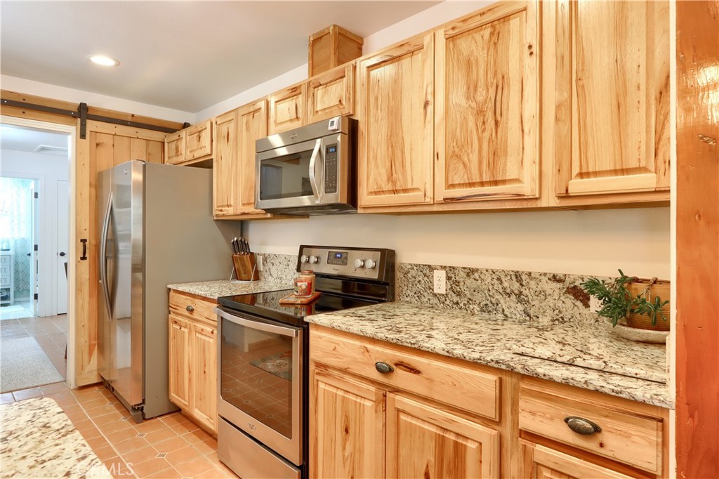 5641B Darrah Road Mariposa, CA 95338 - Photo 12 of 55 a kitchen with stainless steel appliances granite countertop a refrigerator a stove and a sink with granite countertops