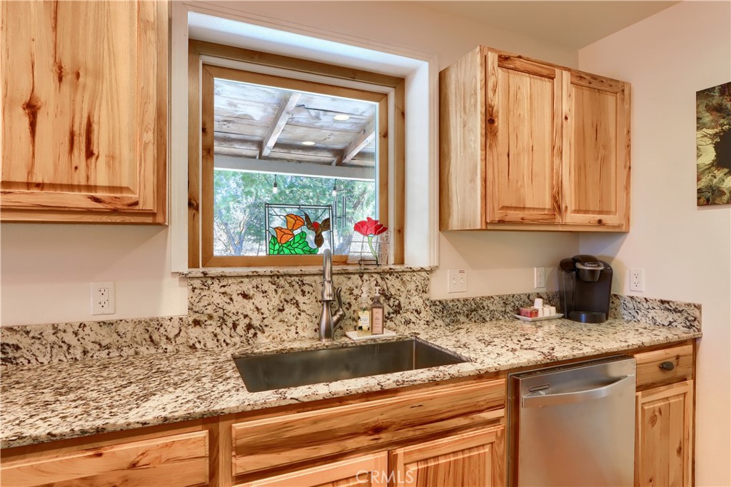 5641B Darrah Road Mariposa, CA 95338 - Photo 13 of 55 a kitchen with granite countertop sink and cabinets