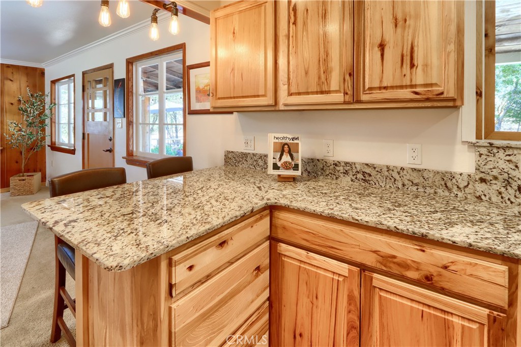 5641B Darrah Road Mariposa, CA 95338 - Photo 14 of 55 a kitchen with granite countertop sink and cabinets