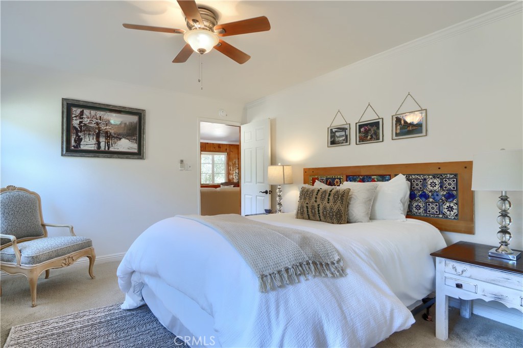 5641B Darrah Road Mariposa, CA 95338 - Photo 18 of 55 a bedroom with a bed and a chandelier