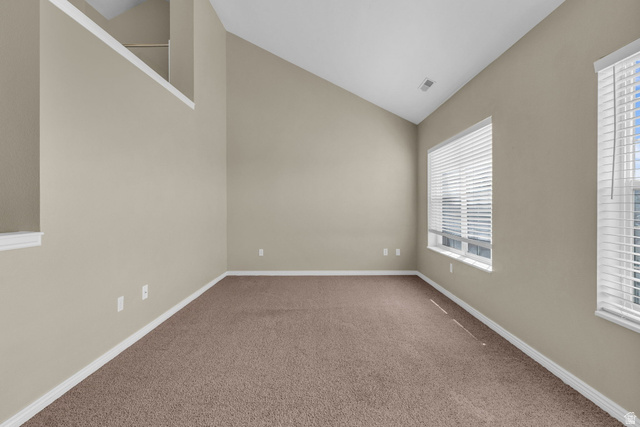 14108 Pepi Band Road Draper, UT 84020 - Photo 18 of 36 Lofted room featuring vaulted ceilings, light-colored walls, brown carpet flooring, and two large windows with blinds