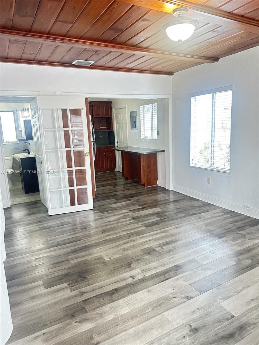 4232 Northwest 2nd Terrace, Unit A Miami, FL 33126 - Photo 3 of 11 a view of a livingroom with wooden floor and window