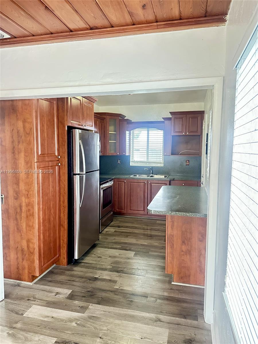 4232 Northwest 2nd Terrace, Unit A Miami, FL 33126 - Photo 4 of 11 a kitchen with stainless steel appliances granite countertop a refrigerator and a sink