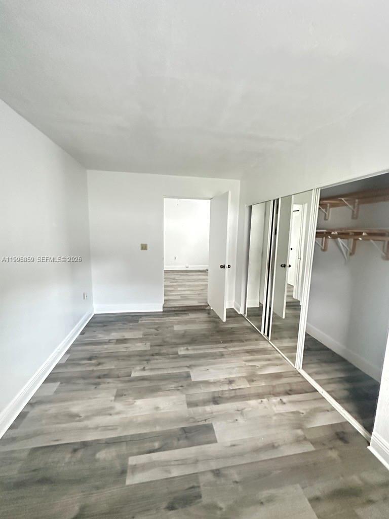 4232 Northwest 2nd Terrace, Unit A Miami, FL 33126 - Photo 8 of 11 a view of a livingroom with wooden floor and closet