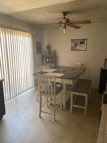 a dining room with furniture and a window
