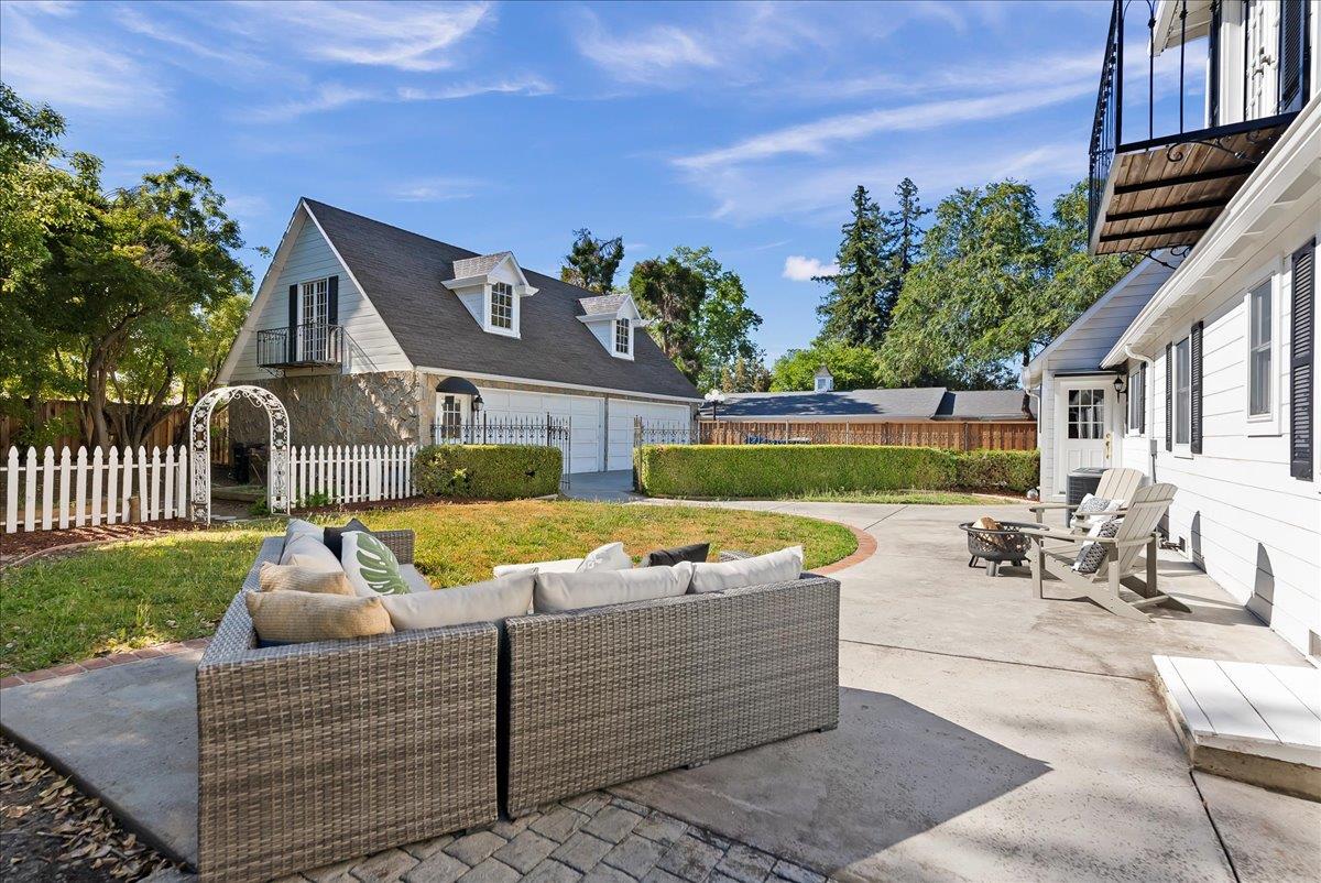 121 Jane Ann Way Campbell, CA 95008 - Photo 31 of 38 a view of a patio with couches table and chairs with potted plants and big yard
