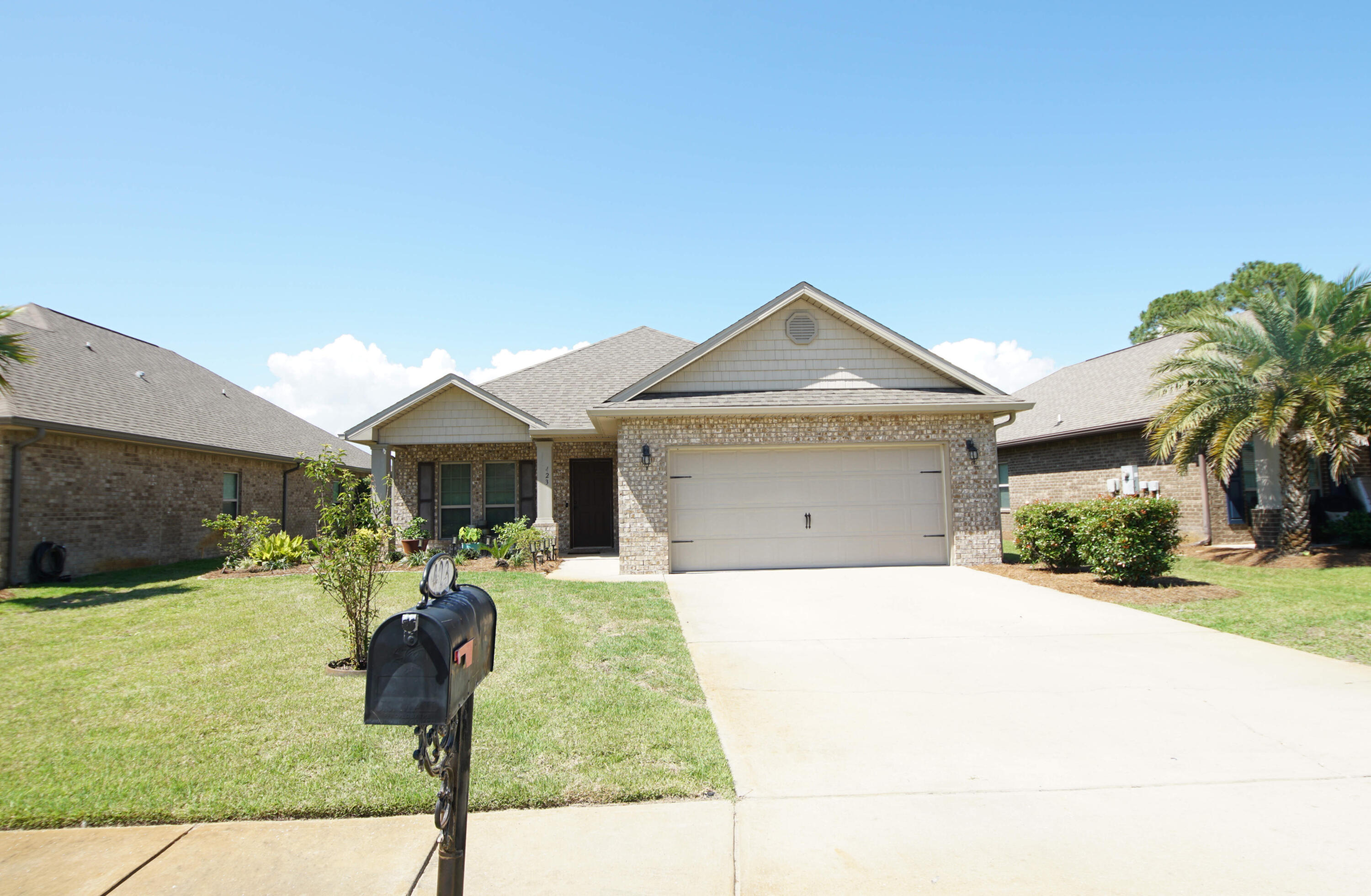 423 Pin Oak Loop Santa Rosa Beach, FL 32459 - Photo 3 of 48 a front view of a house with garden