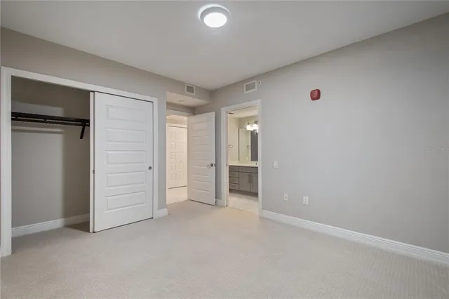 a bathroom with a double vanity sink toilet mirror and shower