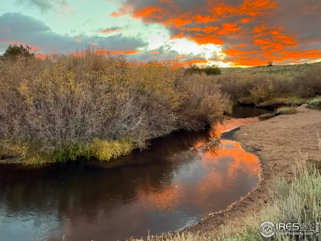 a view of a large building with mountains in the background