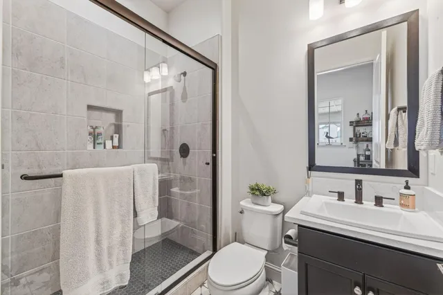 a bathroom with a sink toilet and shower