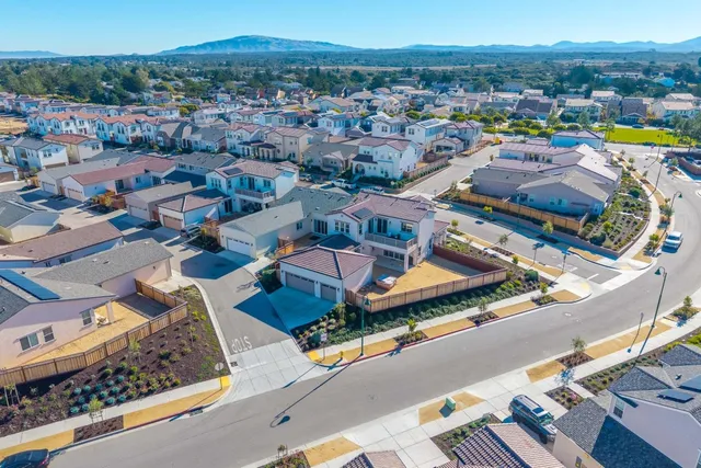 an aerial view of residential houses and city street